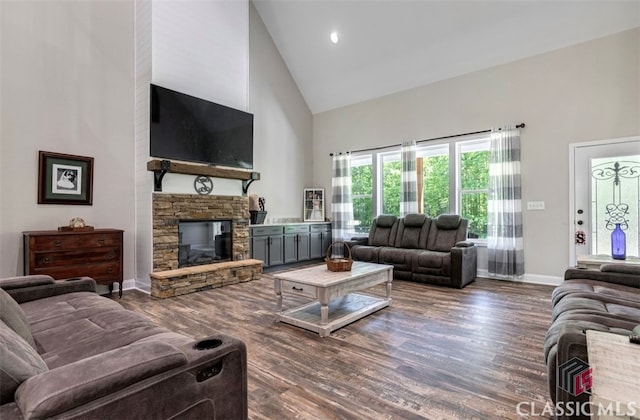 living room featuring a fireplace, high vaulted ceiling, and dark hardwood / wood-style floors