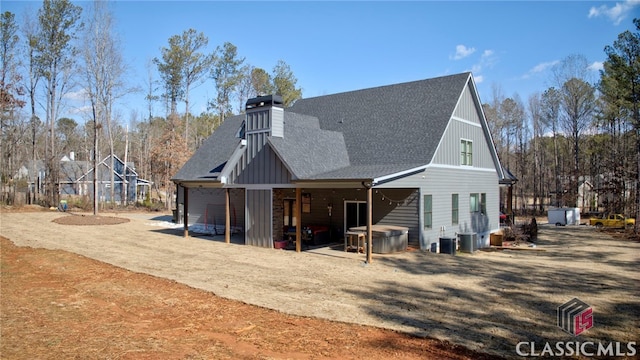 back of house with central AC