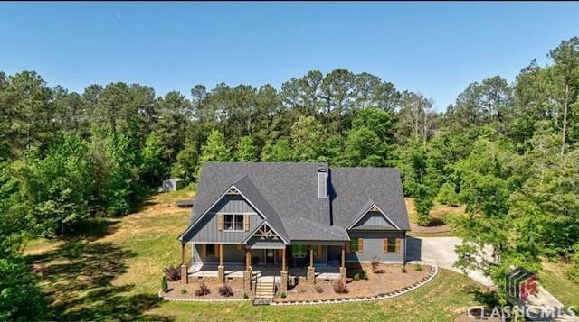 view of front of house with a porch and a front lawn