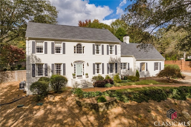 colonial-style house featuring central AC unit