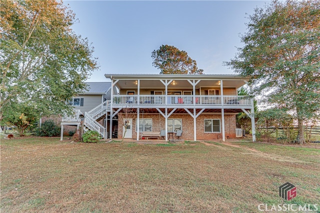 back of house featuring central AC, a lawn, and a wooden deck