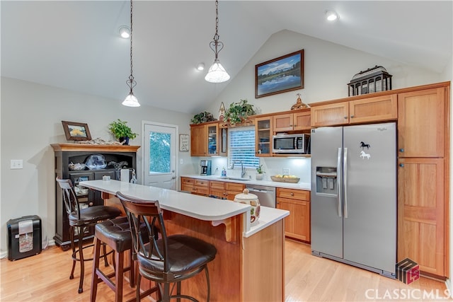 kitchen featuring light hardwood / wood-style floors, stainless steel appliances, sink, and vaulted ceiling