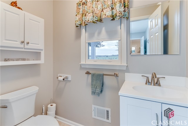 bathroom featuring toilet and vanity