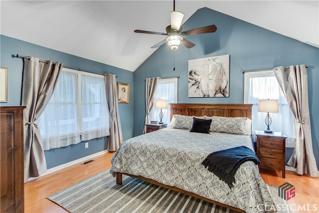 bedroom featuring ceiling fan, light wood-type flooring, and vaulted ceiling