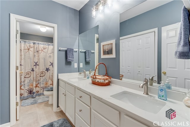 bathroom with a shower with curtain, tile patterned floors, vanity, and toilet