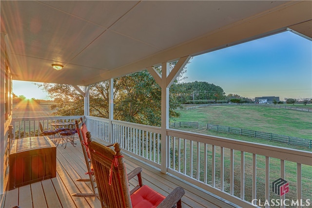 wooden terrace featuring a lawn