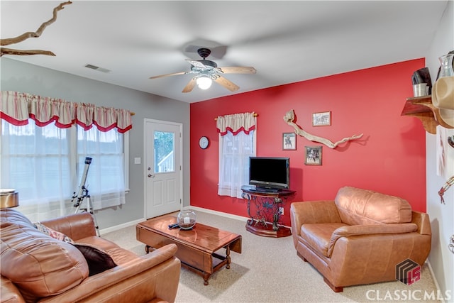 living room featuring carpet floors and ceiling fan