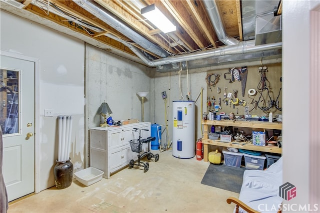 basement with electric water heater and a workshop area