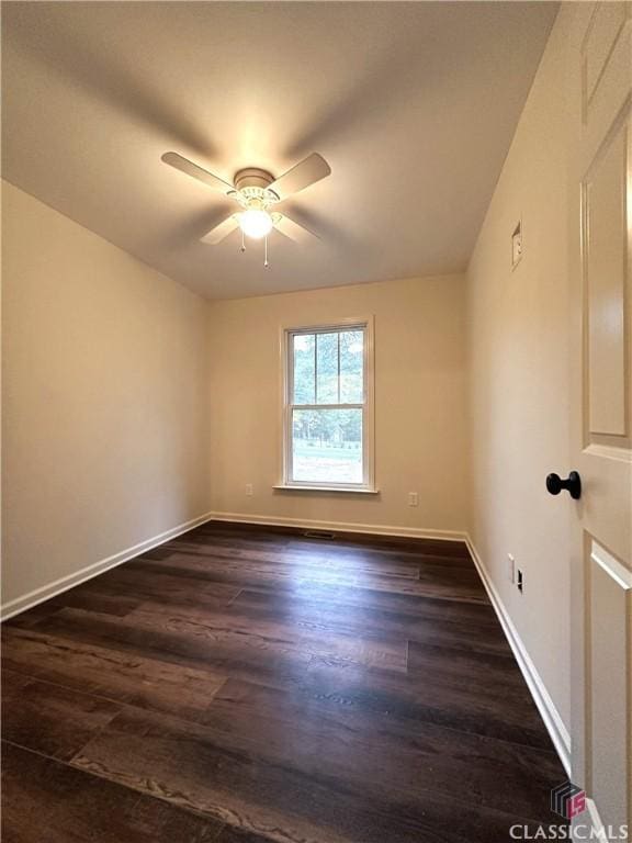 empty room with ceiling fan and dark wood-type flooring