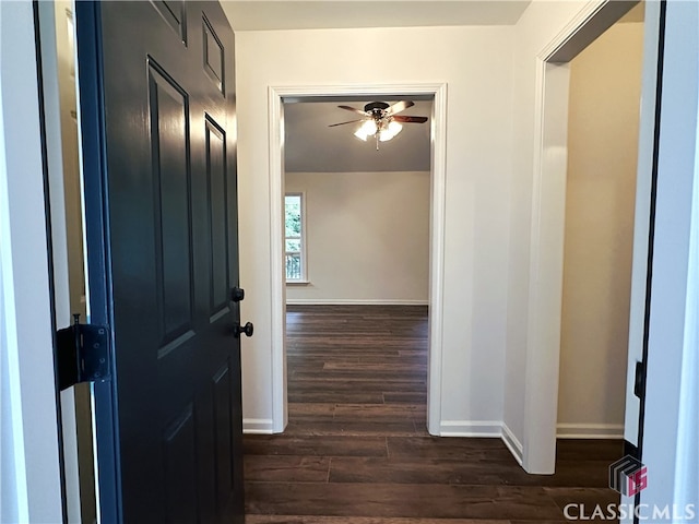 hallway with dark hardwood / wood-style flooring