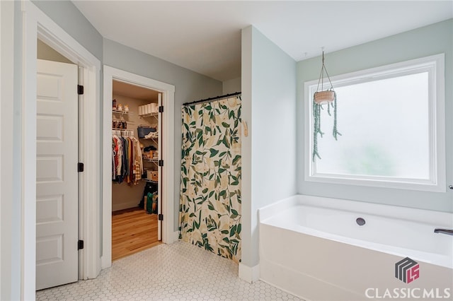 bathroom featuring a bath and tile patterned floors