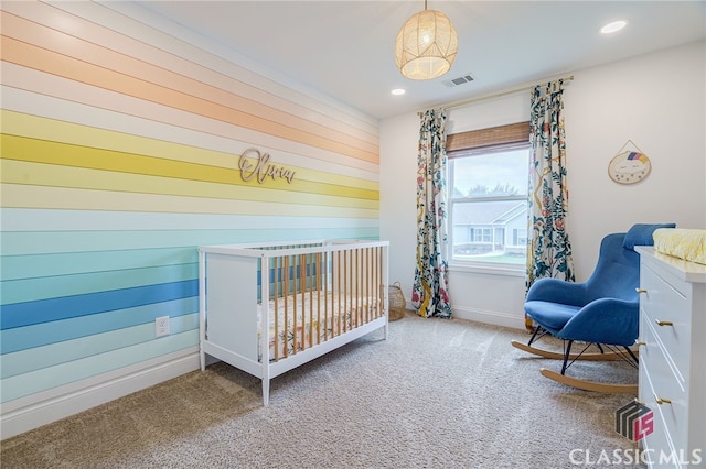 carpeted bedroom with a crib and wood walls