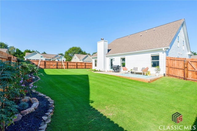 back of property with a lawn and a patio area