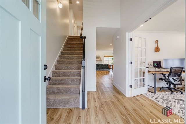 interior space featuring light hardwood / wood-style floors and ornamental molding