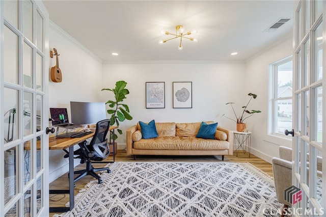 office space featuring wood-type flooring, plenty of natural light, french doors, and ornamental molding