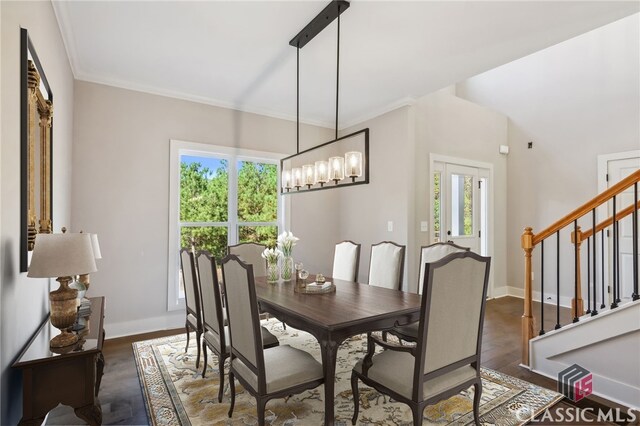 dining area featuring ornamental molding, dark wood-type flooring, and a wealth of natural light