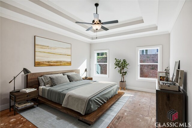 bedroom featuring a tray ceiling, ceiling fan, and crown molding