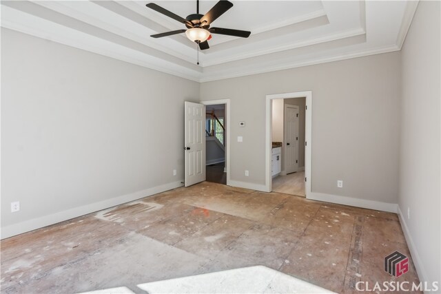 unfurnished bedroom featuring ensuite bath, a raised ceiling, ceiling fan, and crown molding