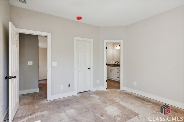 unfurnished bedroom featuring ensuite bath