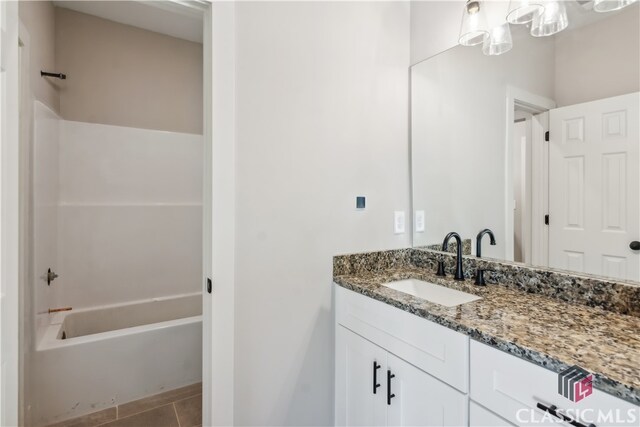 bathroom with tile patterned floors, shower / bathing tub combination, and vanity