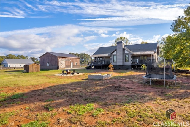 view of yard with a storage shed, a deck, and a trampoline