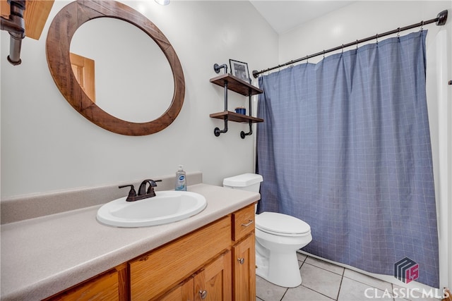 bathroom with vanity, curtained shower, tile patterned floors, and toilet