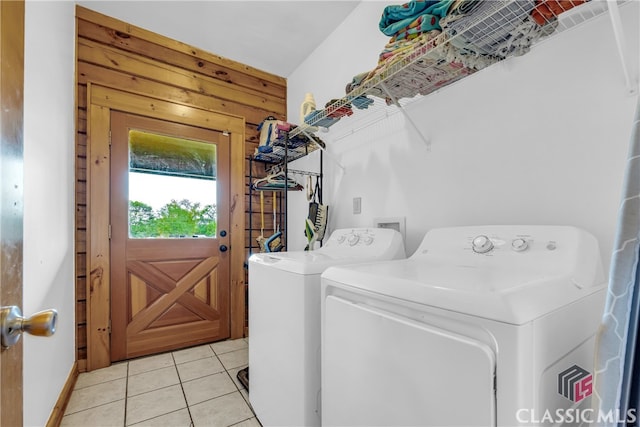 laundry room featuring separate washer and dryer and light tile patterned flooring