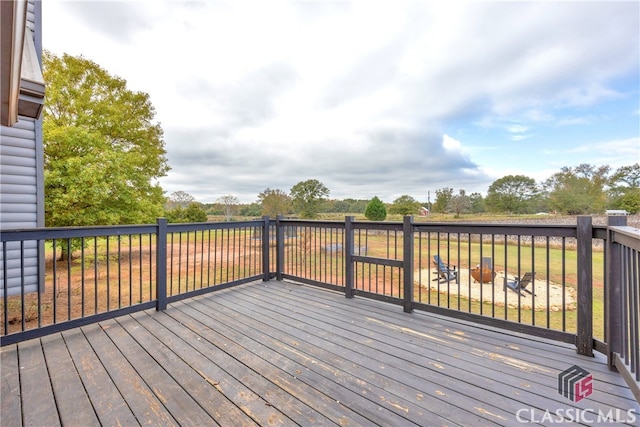 wooden deck with an outdoor fire pit