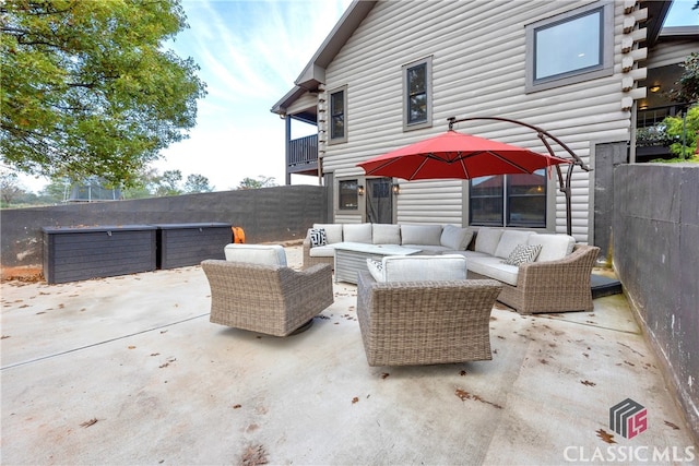 view of patio featuring a trampoline and an outdoor hangout area