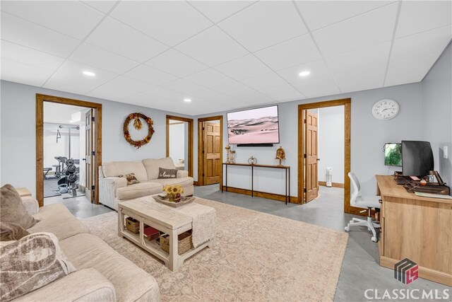 living room with a drop ceiling