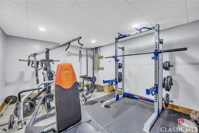 exercise room with a paneled ceiling