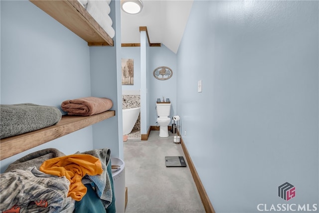 bathroom with vaulted ceiling and toilet