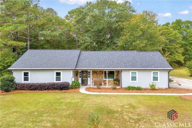 ranch-style home featuring a porch and a front lawn