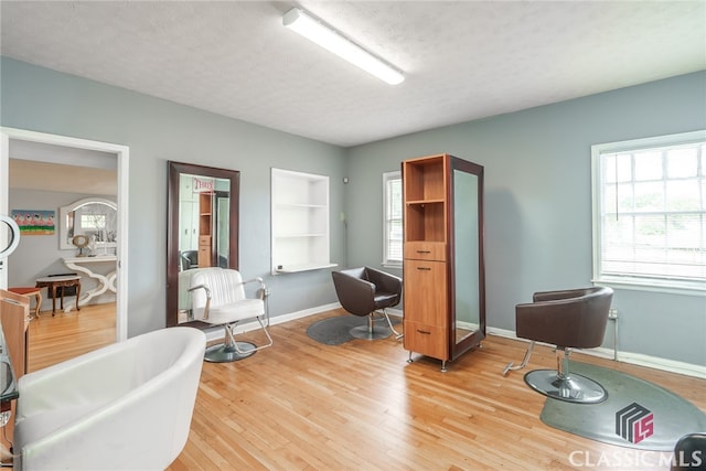 sitting room with wood-type flooring and a textured ceiling