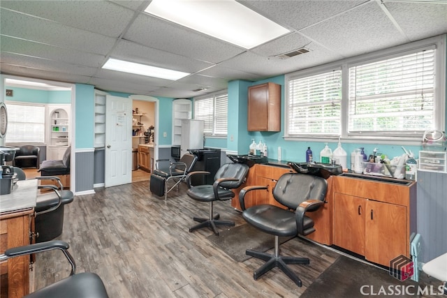 home office featuring a paneled ceiling and hardwood / wood-style floors