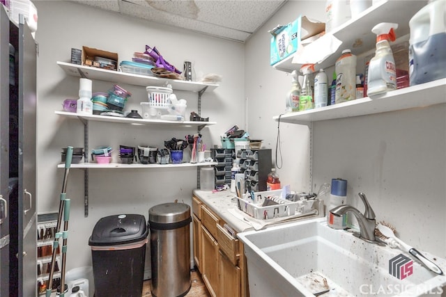 interior space featuring a paneled ceiling and sink