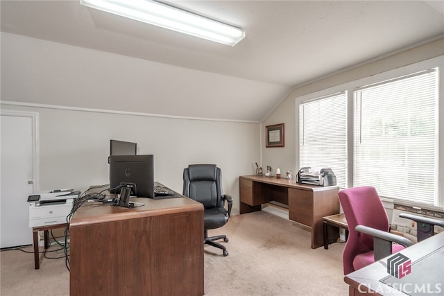 office space with lofted ceiling and light carpet