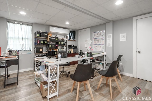 office with a paneled ceiling and hardwood / wood-style flooring