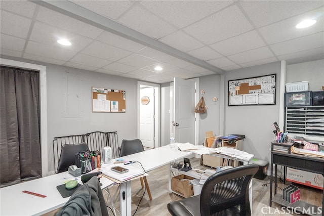 office space with hardwood / wood-style floors and a drop ceiling