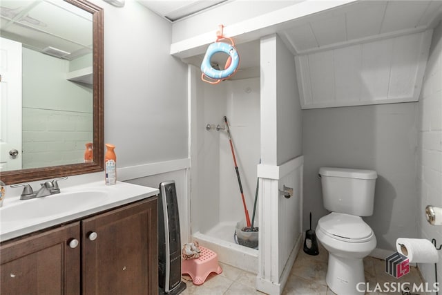 bathroom with a shower, tile patterned flooring, vanity, and toilet