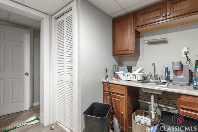 kitchen featuring sink, hardwood / wood-style floors, and a drop ceiling