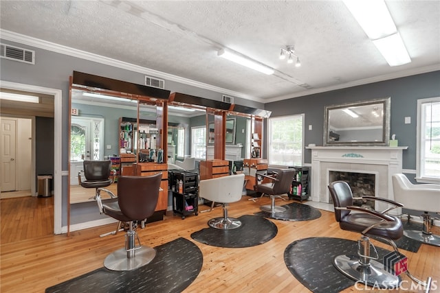 living room featuring a textured ceiling, light wood-type flooring, and plenty of natural light