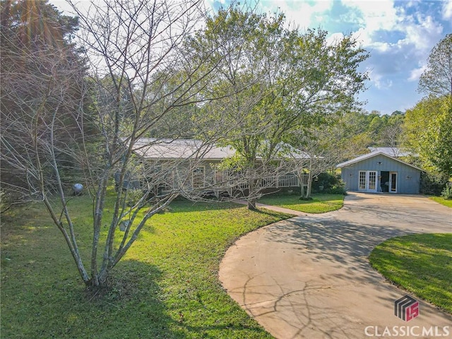 1104 Farm Rd, Colbert, GA 30628 - view of front of property with concrete driveway, french doors, and a front yard