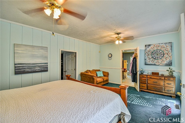 bedroom with ceiling fan, a spacious closet, crown molding, and a closet