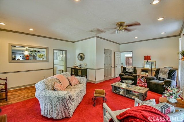 living room with carpet flooring, ceiling fan, and ornamental molding