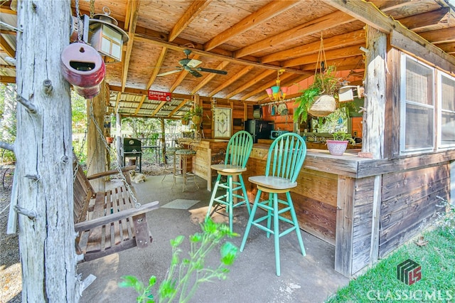 view of patio / terrace featuring ceiling fan and an outdoor bar