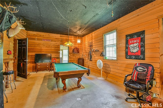 game room featuring concrete flooring, wood walls, and billiards