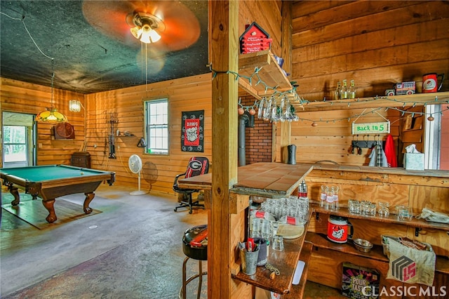 playroom featuring concrete floors, a healthy amount of sunlight, and billiards