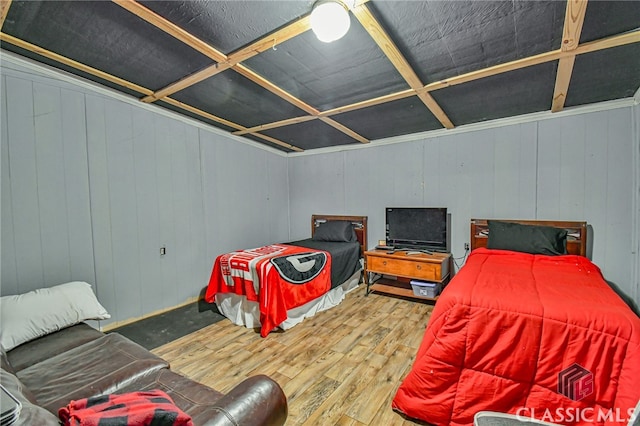 bedroom featuring wood-type flooring, ceiling fan, wooden walls, and coffered ceiling