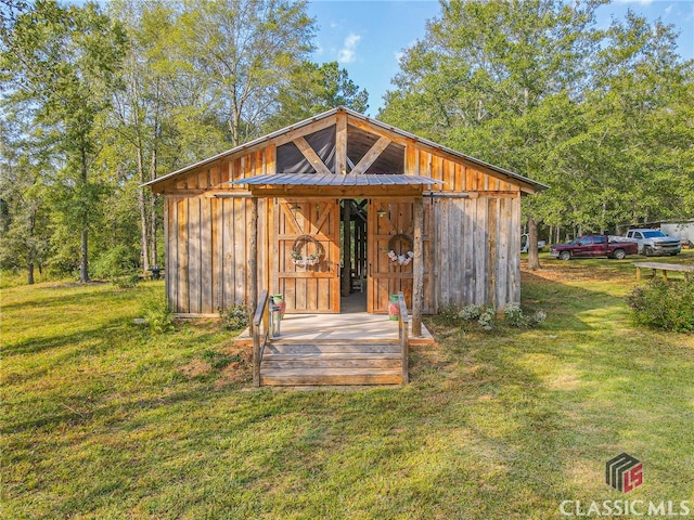 view of outbuilding with a lawn